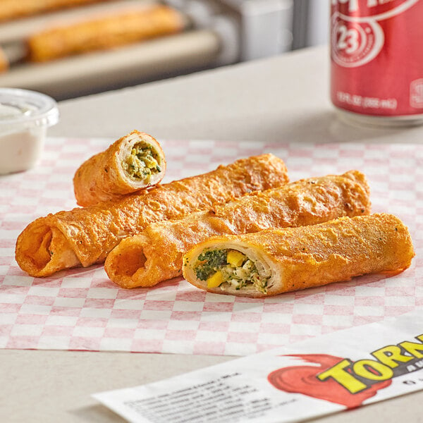 A tray of Ruiz Foods Southwestern Style Chicken Tornado Taquitos with fried food on a plate.