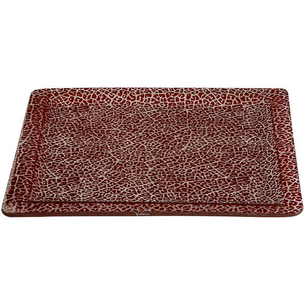 A rectangular red glass platter with a pattern on it.