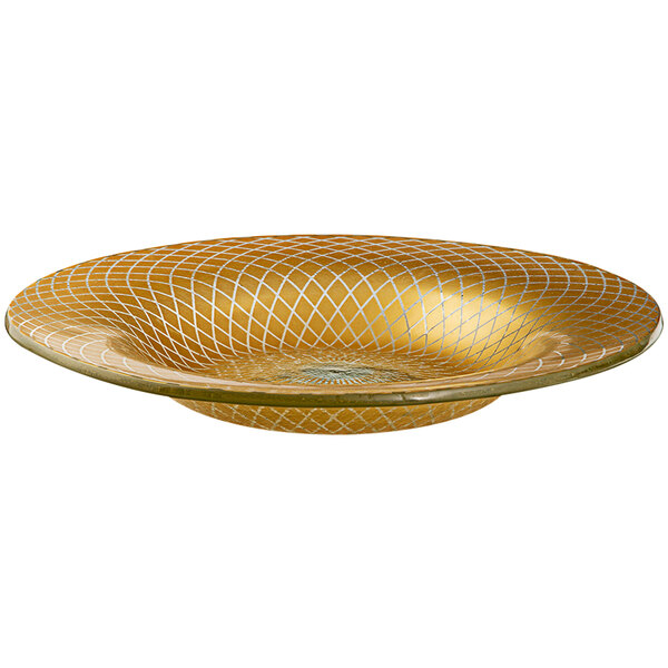 A gold bowl with a white patterned design on the rim.