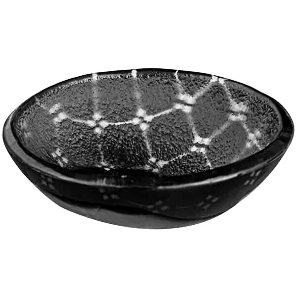 A black bowl with white design on it.