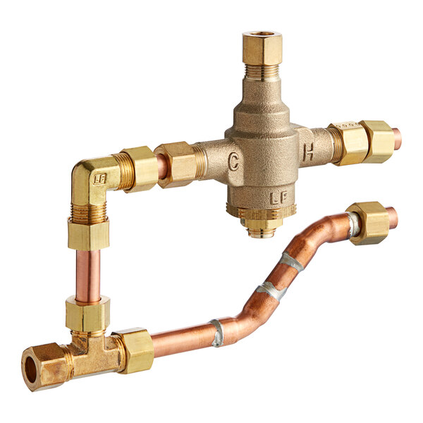 A Stiebel Eltron brass mixing valve with copper and brass pipes.