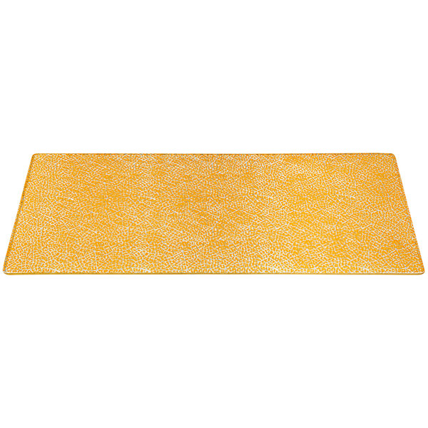 A yellow rectangular glass shelf with a white pattern on it.