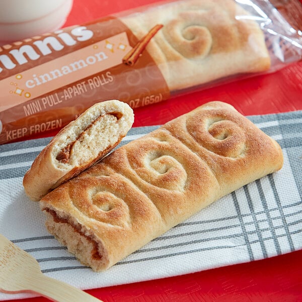 An unwrapped Pillsbury Mini Cinnis cinnamon roll with a spiral design on a white background.
