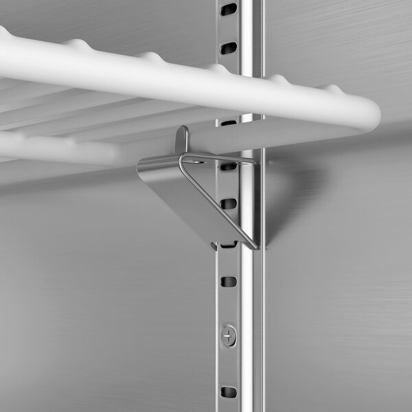 A metal shelf with a metal bracket attached to it inside an Avantco worktop freezer.