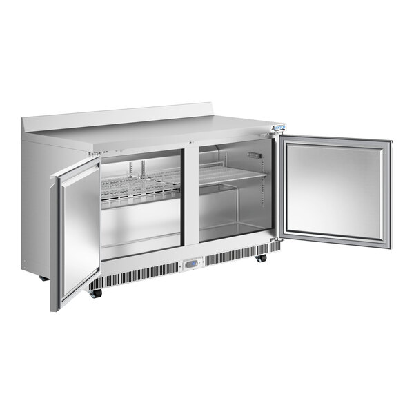 A stainless steel worktop freezer with two open doors, interior shelving, and a 3 1/2 inch backsplash.