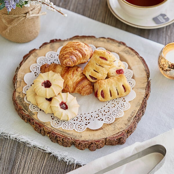 A plate of pastries and tea on a table with Lace Normandy Doilies.