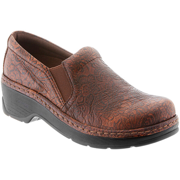 A pair of brown leather Klogs women's clogs with a black sole.