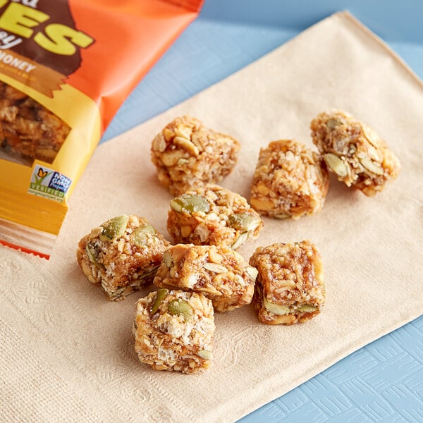 A bag of Bear Naked Peanut Butter and Honey Granola Bites on a napkin on a table.