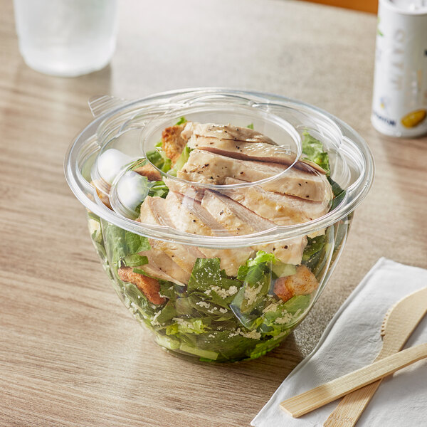 A salad in a clear plastic container with a clear lid.