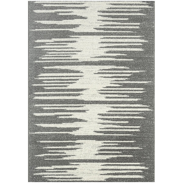 A grey and white abstract geometric area rug with jagged lines.