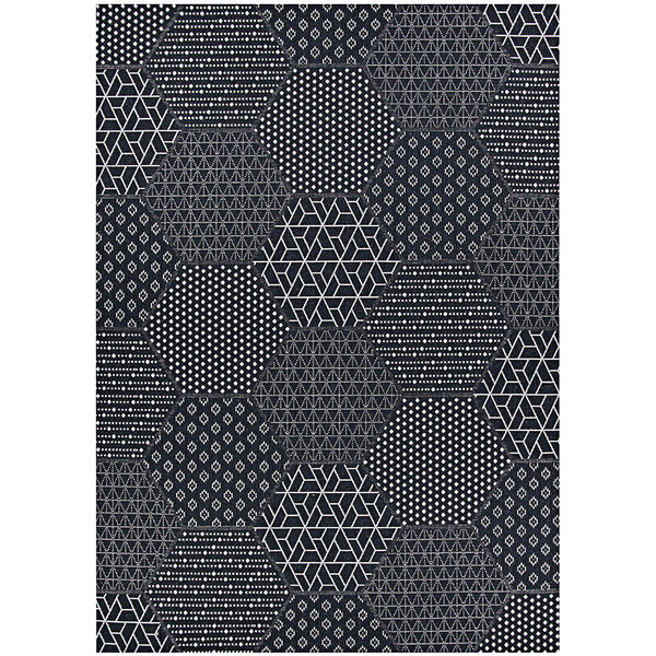 A close up of a Couristan Afuera Anode black and white hexagon patterned rug.