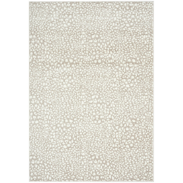 A cream and beige cheetah print area rug.