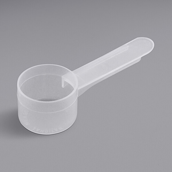 A clear plastic container of 13 cc Polypropylene Scoops with medium white handles.