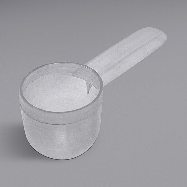 A clear plastic measuring bowl with a short handle.