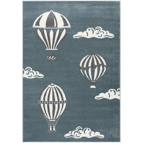 A blue area rug with hot air balloons in the sky.