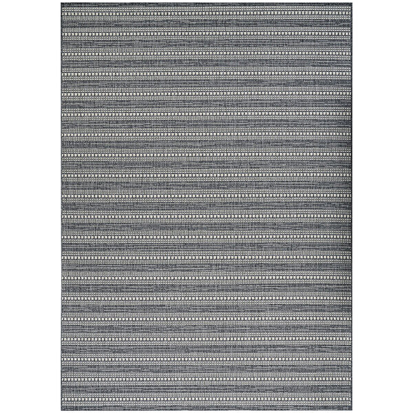 A close up of a Couristan Afuera Beachcomber area rug with gray and white stripes and a small design.