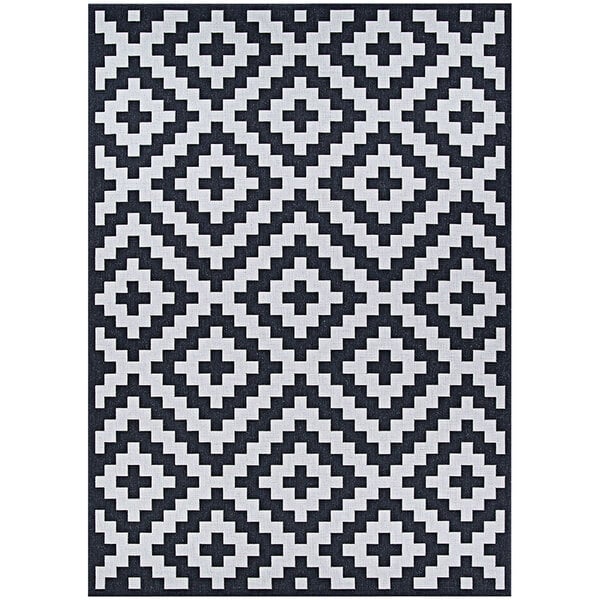 A Couristan Afuera Diatomic area rug with a black and white geometric pattern.