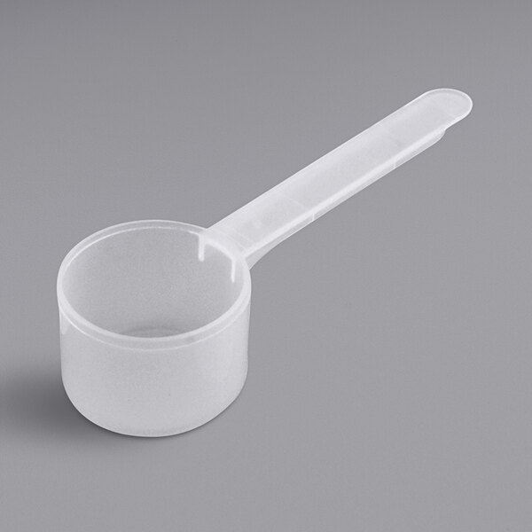 A white plastic measuring scoop with a long white handle.
