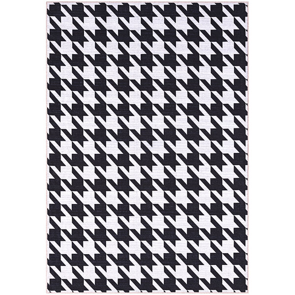 An Abani Parker Collection cream rug with a black and white houndstooth pattern and white border.