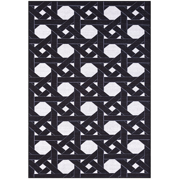 An Abani Parker Collection cream and black area rug with geometric designs.
