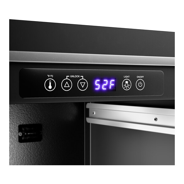 A digital control panel on a commercial wine cooler displaying the temperature as 52°F.