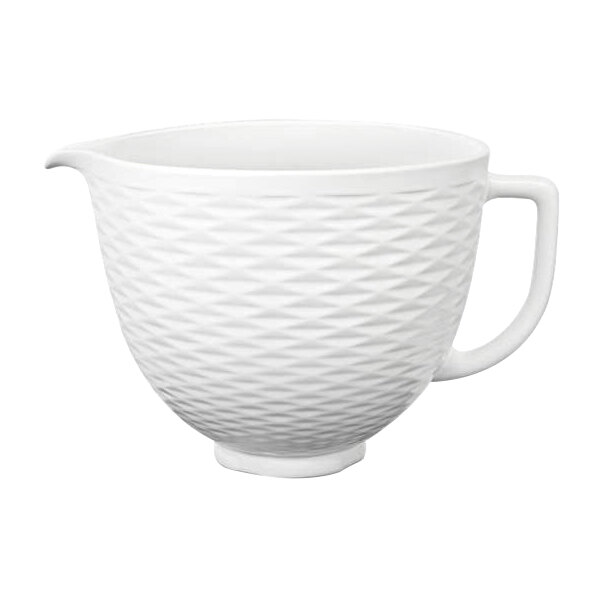 A white KitchenAid ceramic mixing bowl with a textured handle.