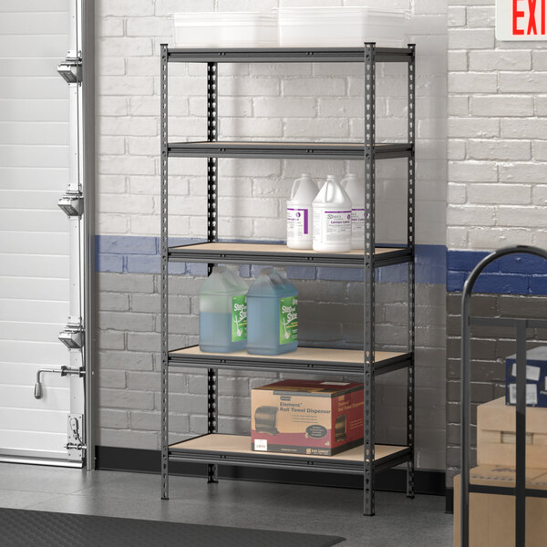 A Lavex black metal boltless shelving unit in a garage with bottles on it.