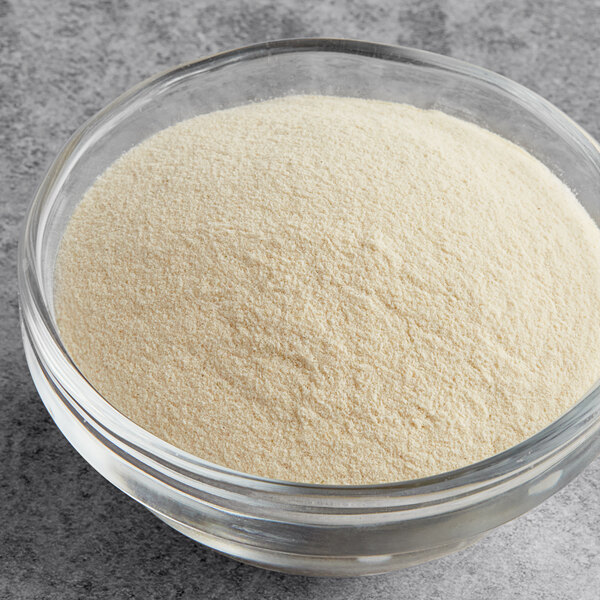 A bowl of Regal Organic Onion Powder on a table.