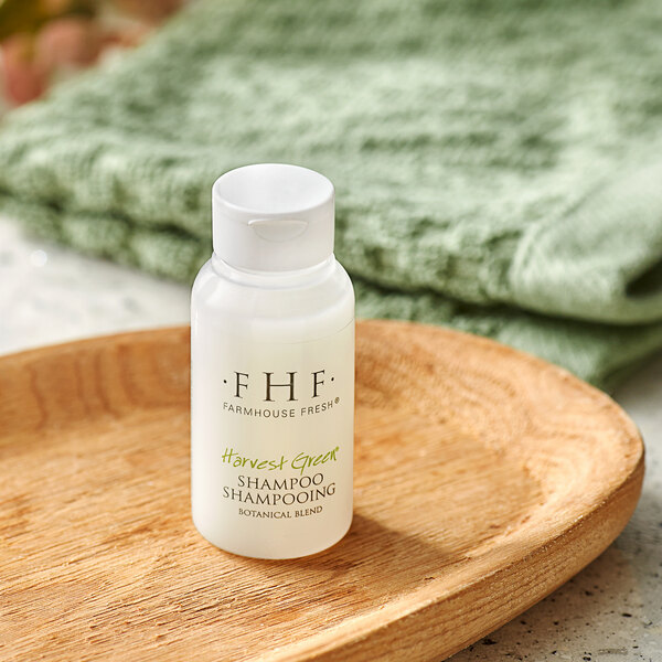 A white bottle of FarmHouse Fresh Botanical Blend Shampoo on a wooden surface.