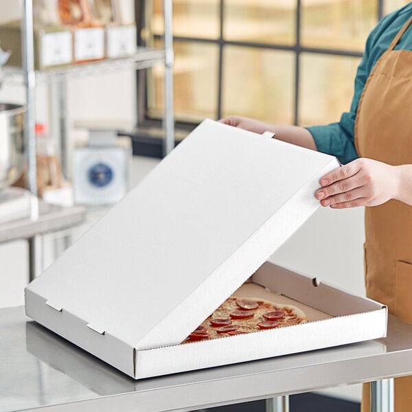 A person opening a Choice white corrugated pizza box.