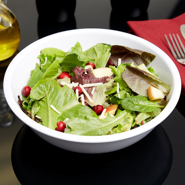A Carlisle white melamine bowl filled with salad with cranberries, apples, and pears.