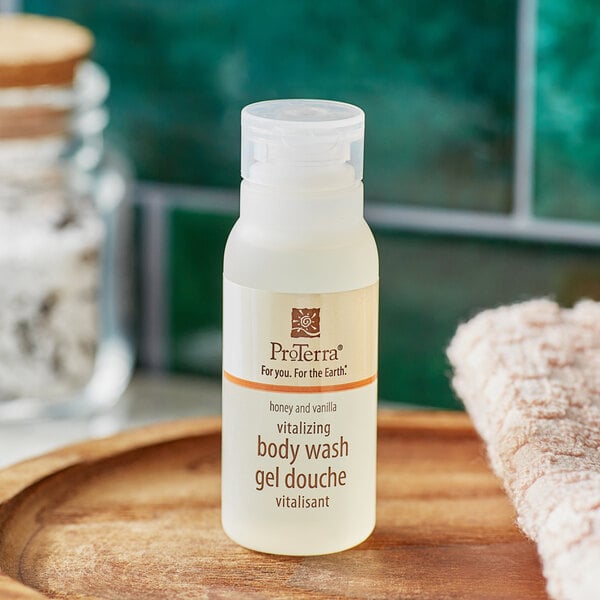 A close-up of a small ProTerra bottle of Honey and Vanilla body wash.