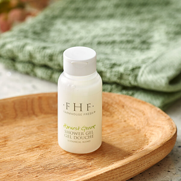 A white bottle of FarmHouse Fresh Botanical Blend shower gel on a wooden dish.