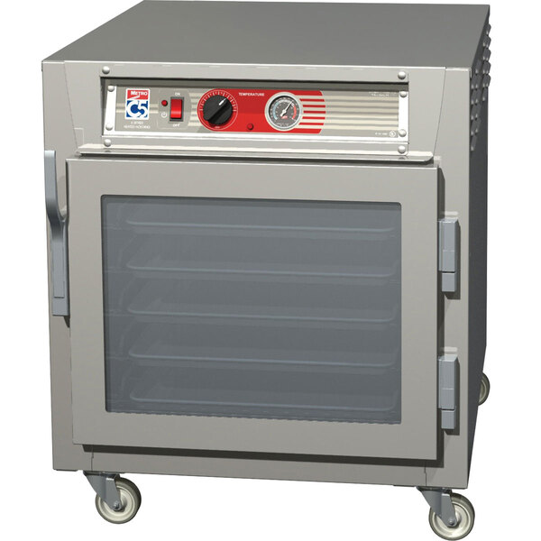 A Metro C5 6 Series under counter heated holding cabinet with clear doors on wheels.