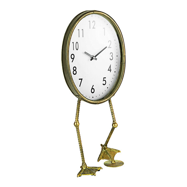 A gold table clock with duck feet.