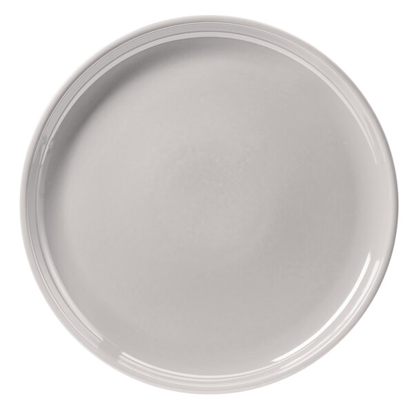 A close up of a Hall China bright white plate with a rim.
