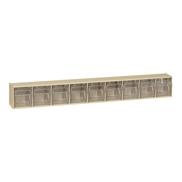 A clear plastic shelf with 9 ivory tip-out bins.