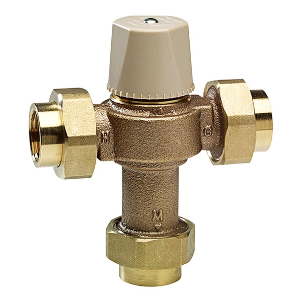 A close-up of a Chicago Faucets brass thermostatic mixing valve with two brass handles.