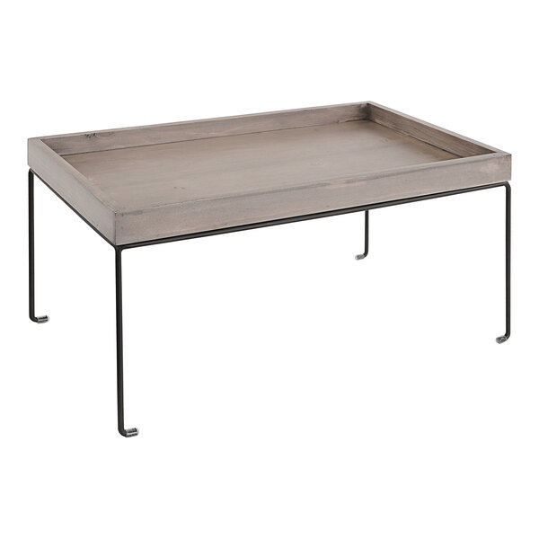 A Cal-Mil gray-washed pine wood display riser with removable metal legs on a table.