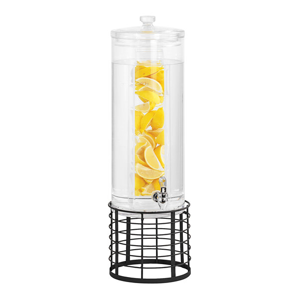 A Cal-Mil round glass beverage dispenser with lemons inside on a black wire base.