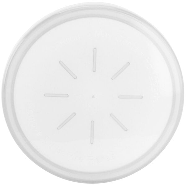 A white plastic lid with a circular hole and lines in the center.