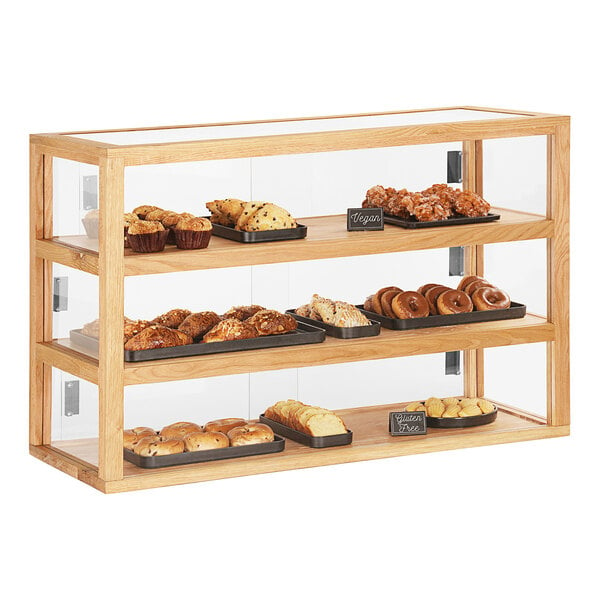 A Cal-Mil bakery display case with various pastries on each tier.