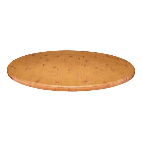 A Perfect Tables 36" round knotty pine table top on a wooden table.