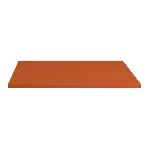 A rectangular tangerine table top on a table.