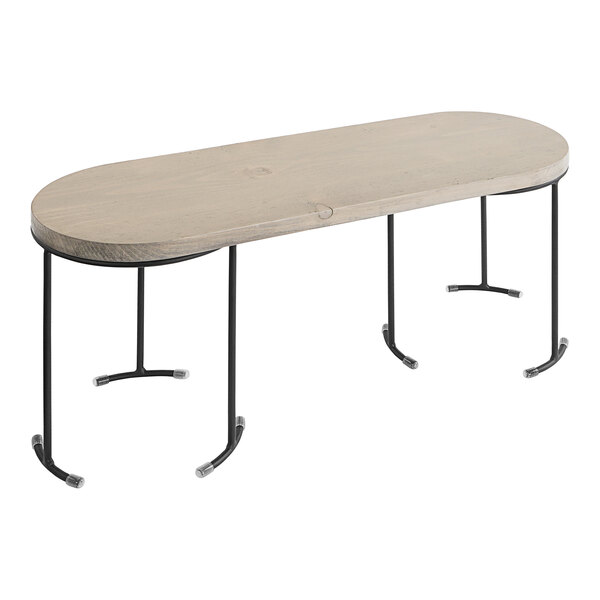 A Cal-Mil wooden display riser with a removable metal base on a wood table with metal legs.