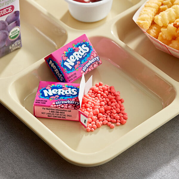 A white tray of Nerds strawberry treat-sized candy boxes on a table.