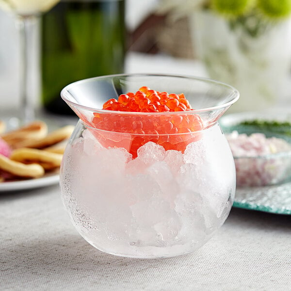 An Acopa glass bowl filled with ice and red caviar.