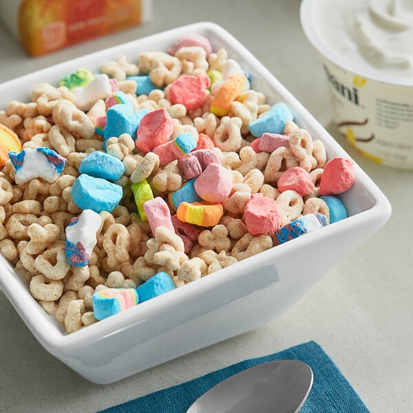 A bowl of Lucky Charms cereal with colorful cereal and marshmallows.