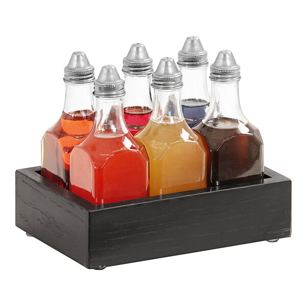 A Cal-Mil rustic pine wood caddy holding 6 clear glass bitters bottles filled with different colored liquid.