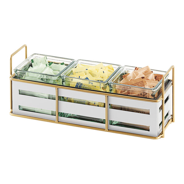 A white metal tray with gold accents and three glass jars on a row of condiments.